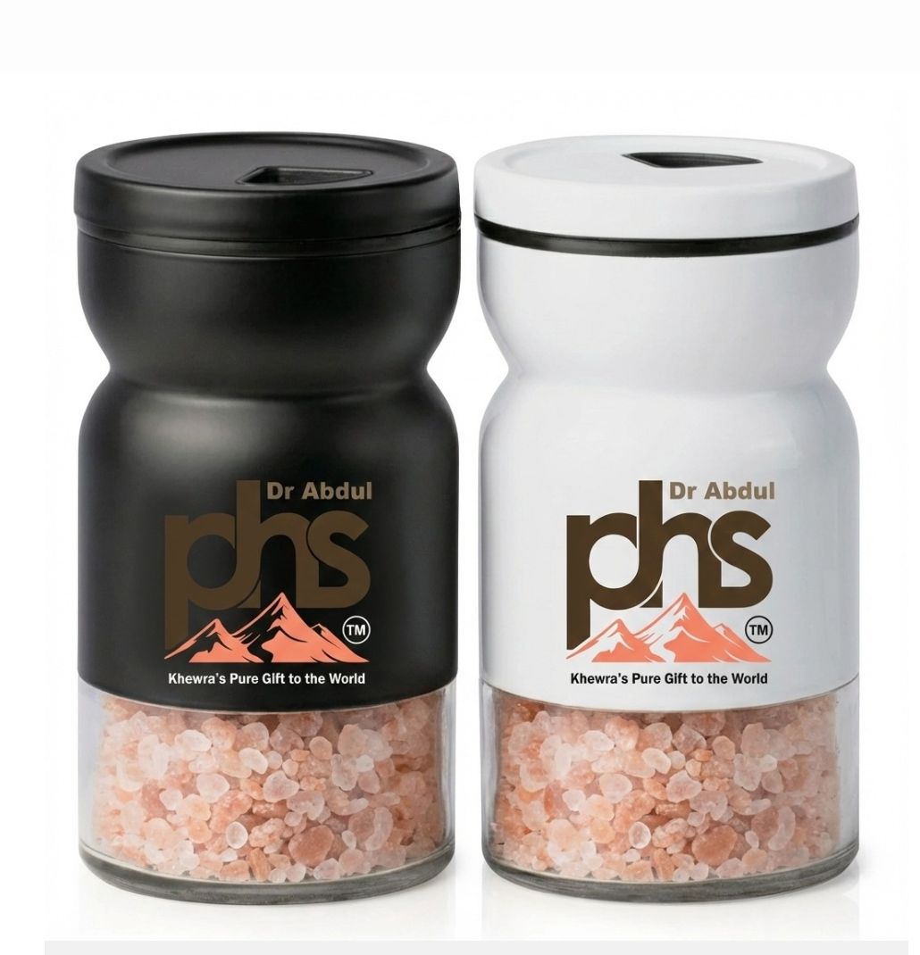 Black and white Himalayan salt grinders with wooden tops.